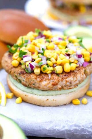 topping a turkey patty with corn salsa