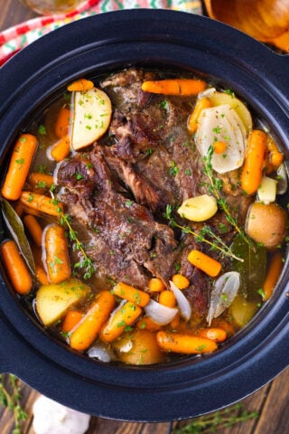 Tender red wine slow cooker pot roast with potatoes and carrots.
