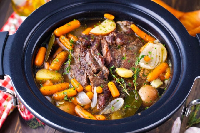 Tender red wine slow cooker pot roast with root vegetables.