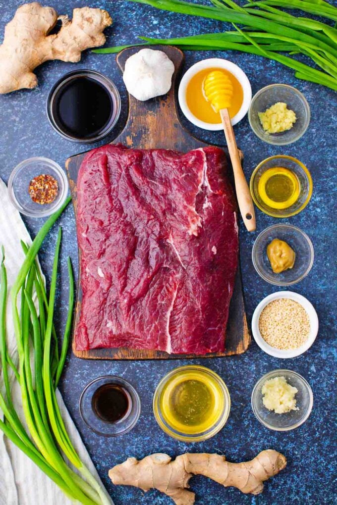 sticky honey garlic beef ingredients in bowls on a table