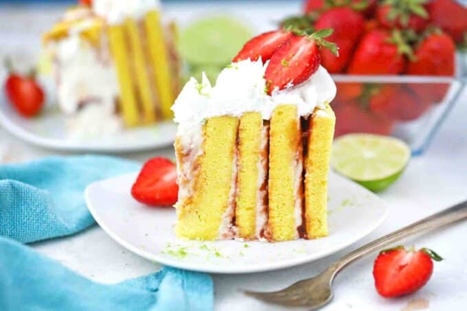 slices of strawberry lime cake with vertical layers served with fresh strawberries