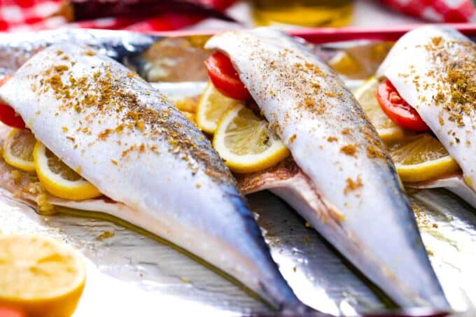 stuffed Spanish mackerel with lemon slices and halved grape tomatoes