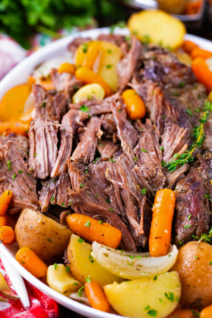 Shredded red wine slow cooker pot roast with root vegetables.