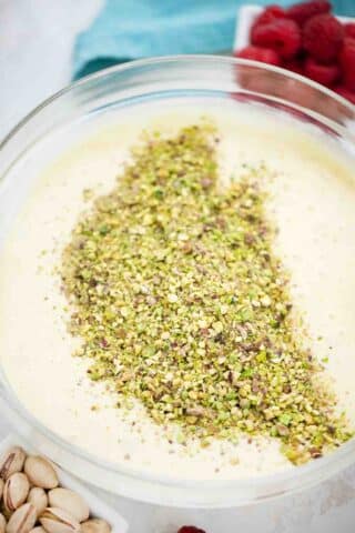 adding chopped pistachios to cake batter