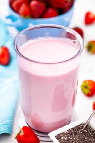 blended strawberries with yogurt and milk in a blender