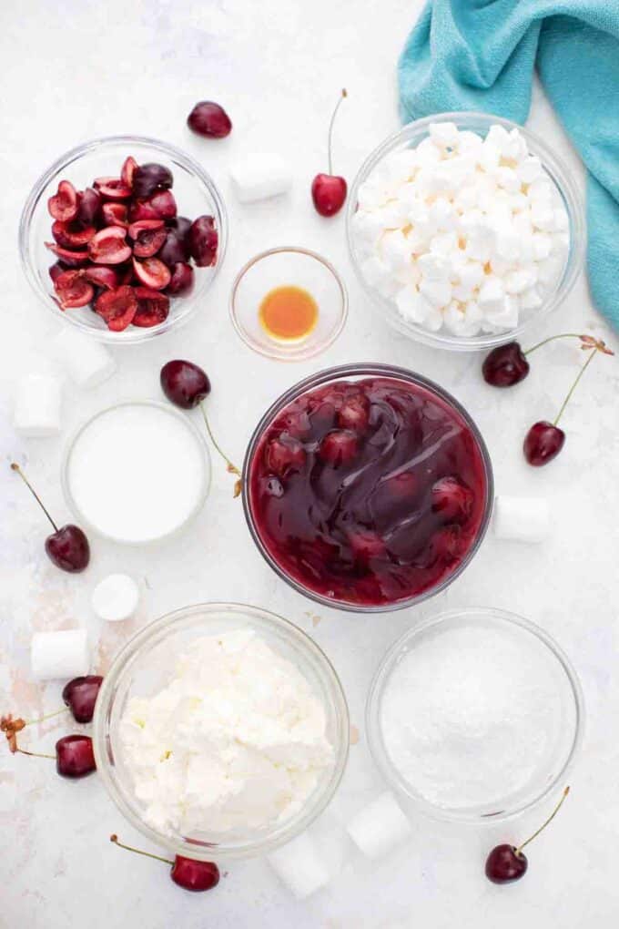 overhead shot of cherry cheesecake fluff ingredients in bowls on a table