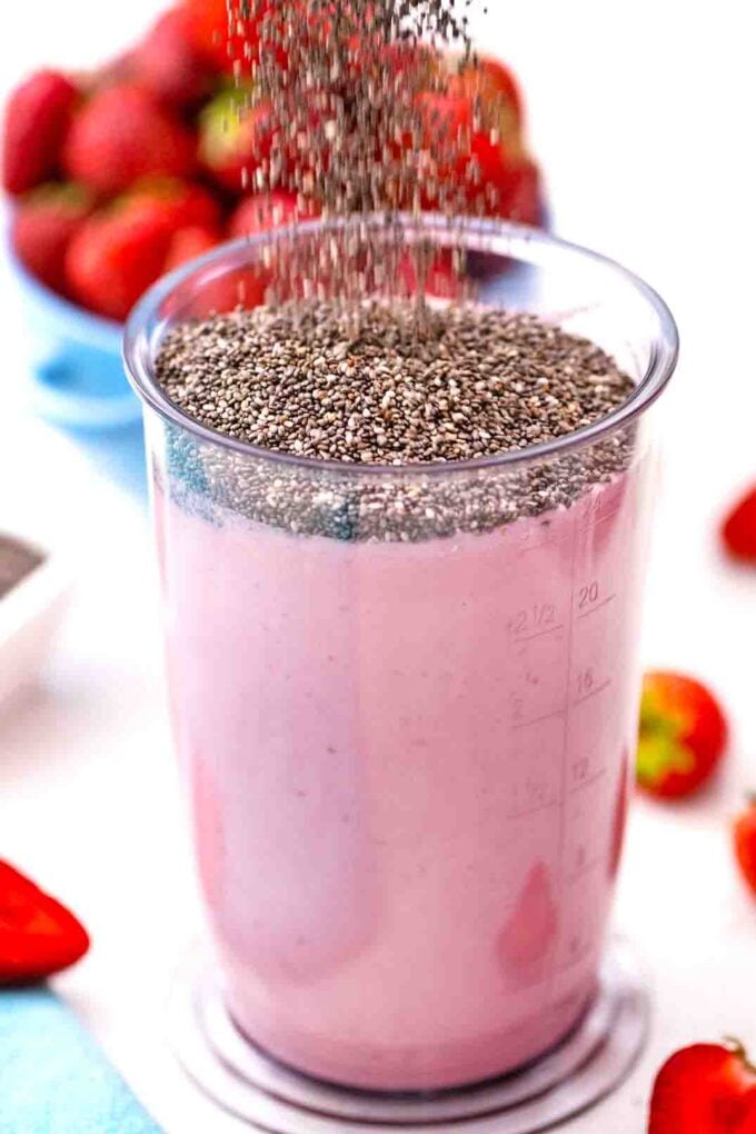 adding chia seeds to strawberry yogurt and milk mixture
