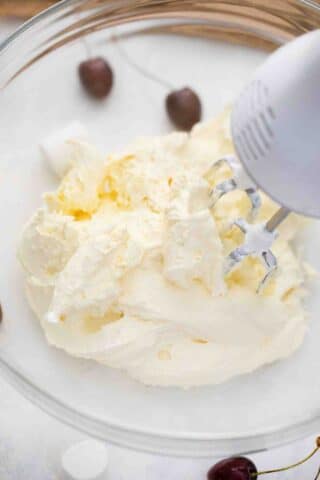 beating cream cheese with a hand mixer