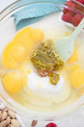 mixing eggs and pistachio paste in a bowl