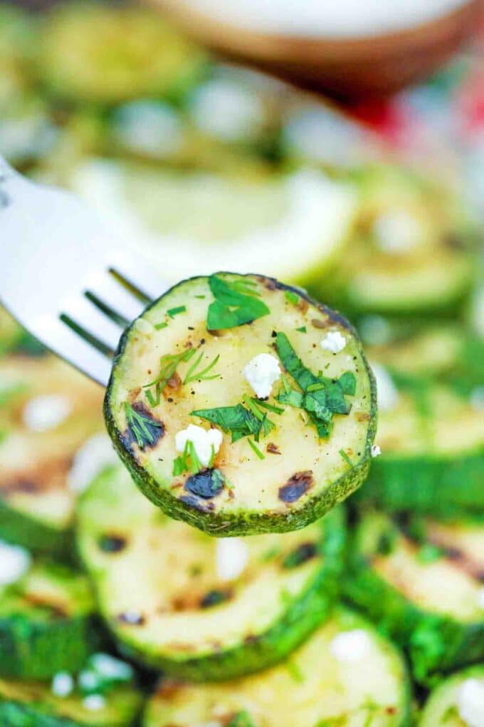 a grilled zucchini round on a fork