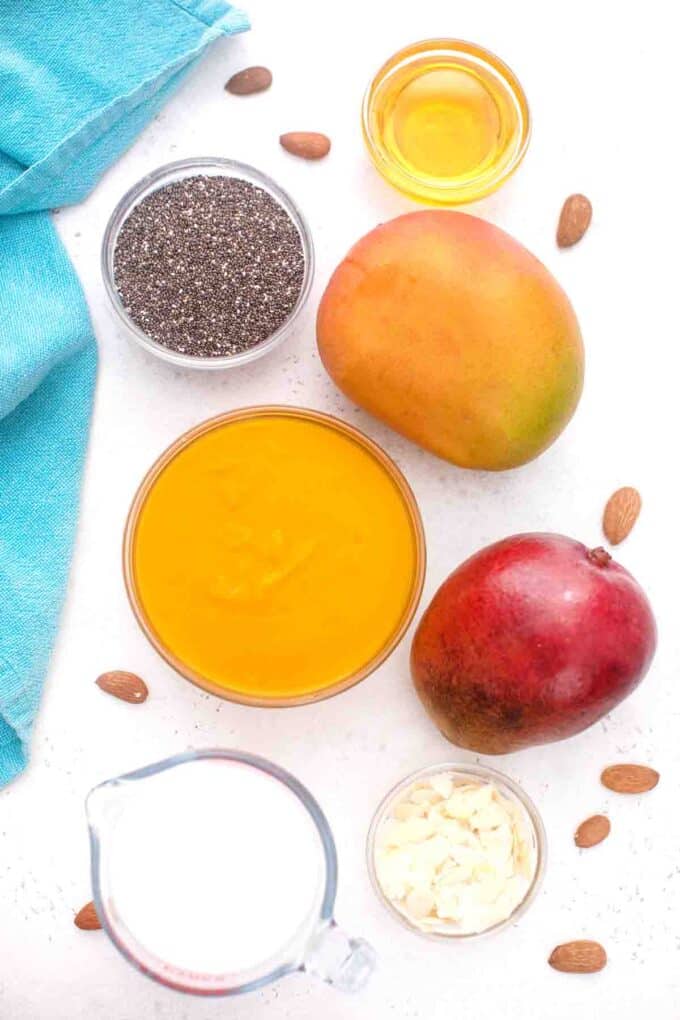 overhead shot of mango chia pudding ingredients in bowls on a table
