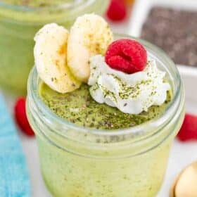 matcha chia pudding in a jar topped with whipped cream and bananas