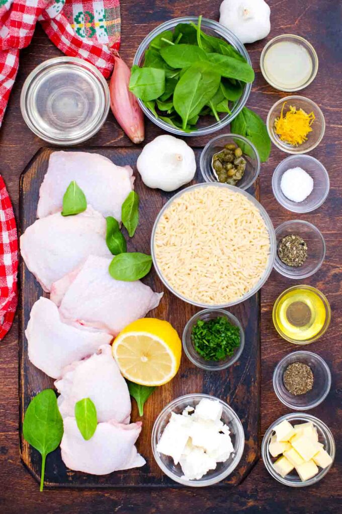 overhead shot of one pan chicken and orzo ingredients in bowls on a table