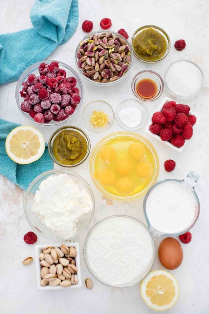 overhead shot of pistachio raspberry swiss roll ingredients in bowls on a table