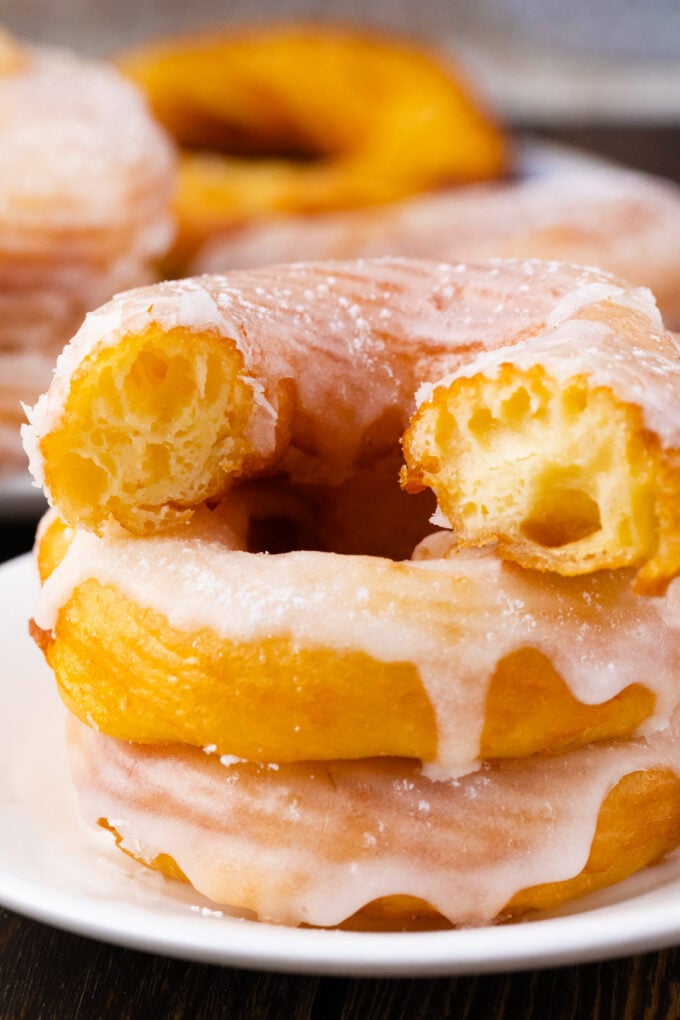 Homemade Dunkin Donuts French cruller showing its soft inside and crunchy top.