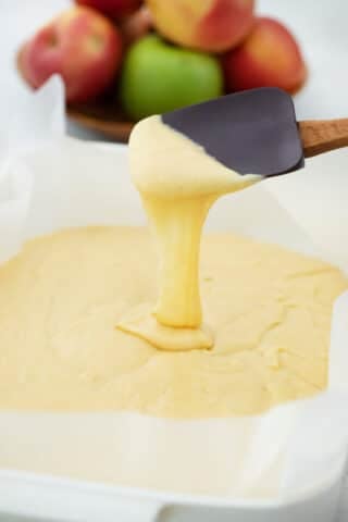 pouring cake batter into a pan