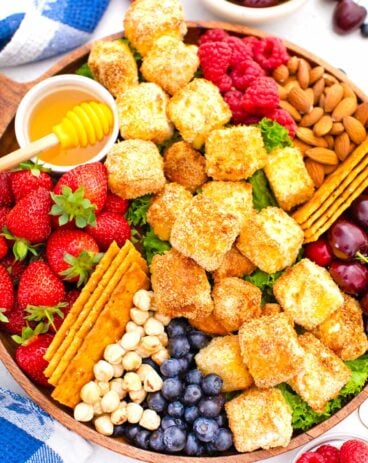 overhead shot of air fried brie platter with honey buts and berries