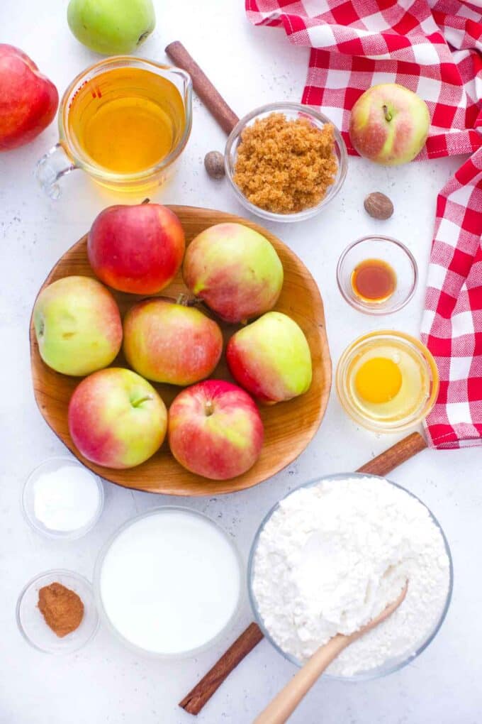 overhead shot of apple cider donuts ingredients in bowls on a table