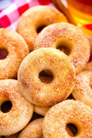 close overhead shot of apple cider donuts on a wooden tray