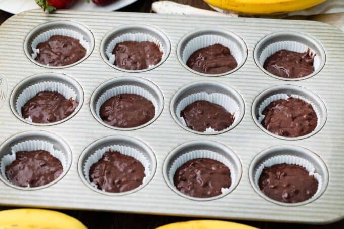 Chocolate banana bread muffins in a muffin tin.