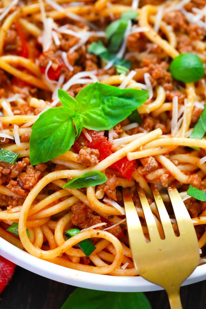 A plate of instant pot spaghetti with fresh basil.