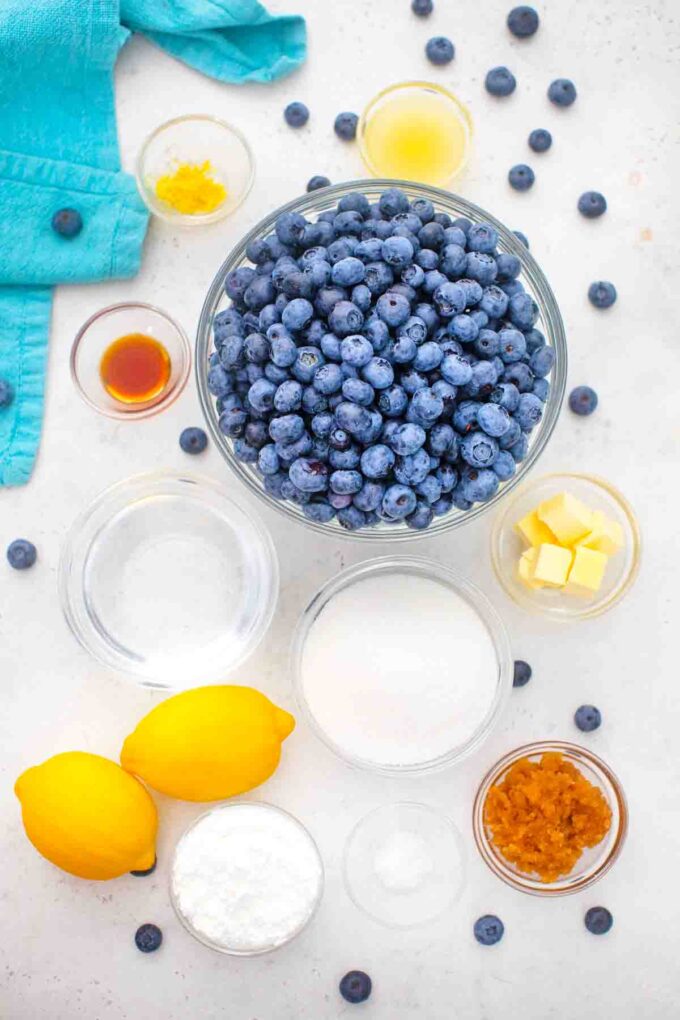 overhead shot blueberry pie filling ingredients in bowls on a table
