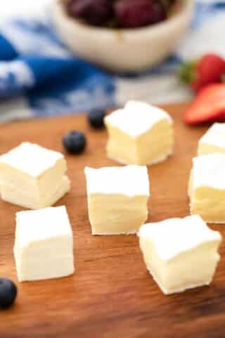brie cubes on a wooden board