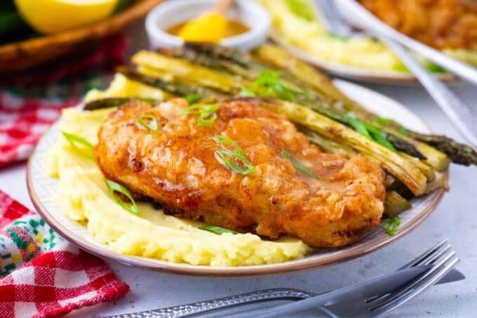 Cheesecake factory honey truffle chicken served with mashed potatoes and roasted asparagus.