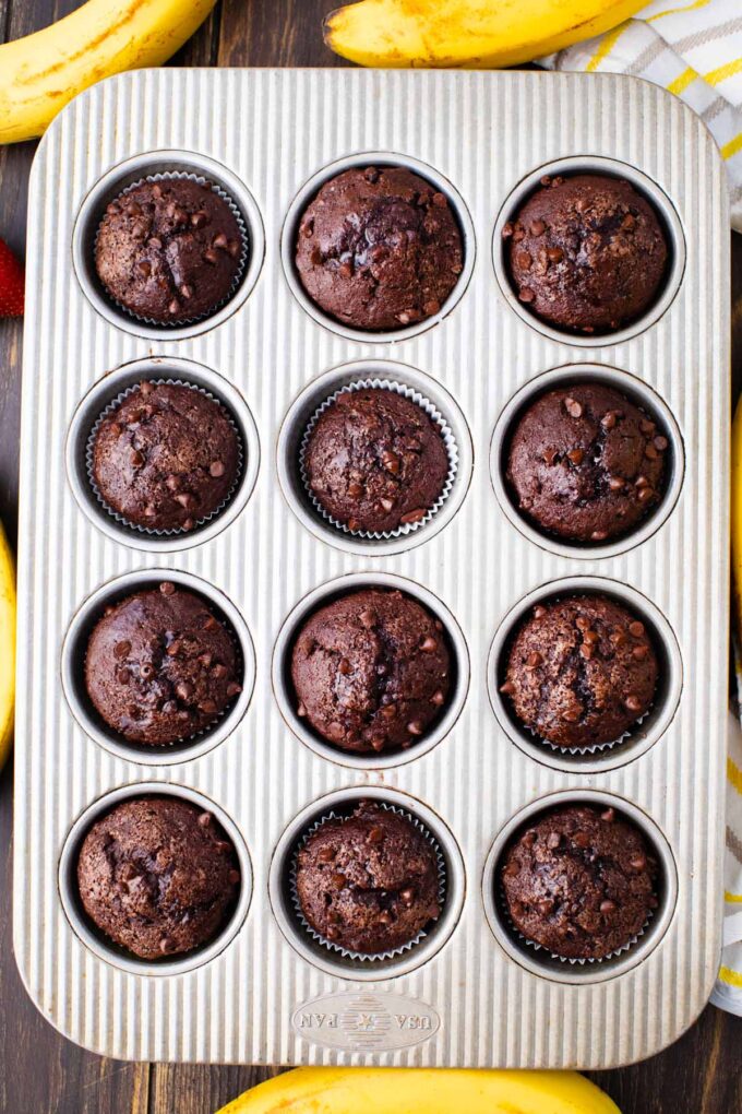 Overhead shot of Chocolate banana muffins with chocolate chips in a muffin tin.