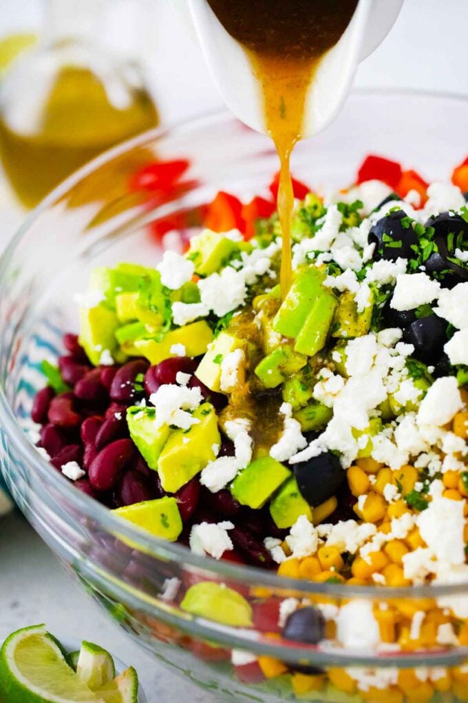 pouring dressing over salad