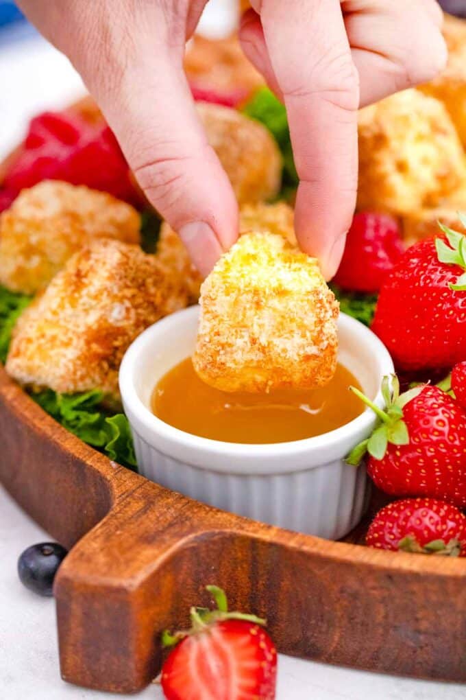 dipping and air fried brie cube into honey