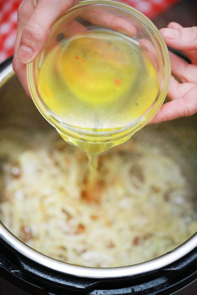 Deglazing instant pot with chicken broth.