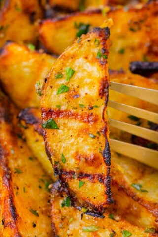 Crispy grilled potato on a fork.
