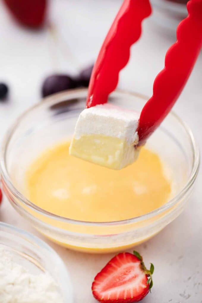 dipping brie cube in egg mixture