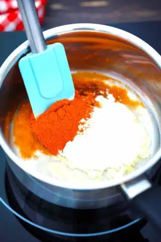 stirring flour and chili powder in a saucepan