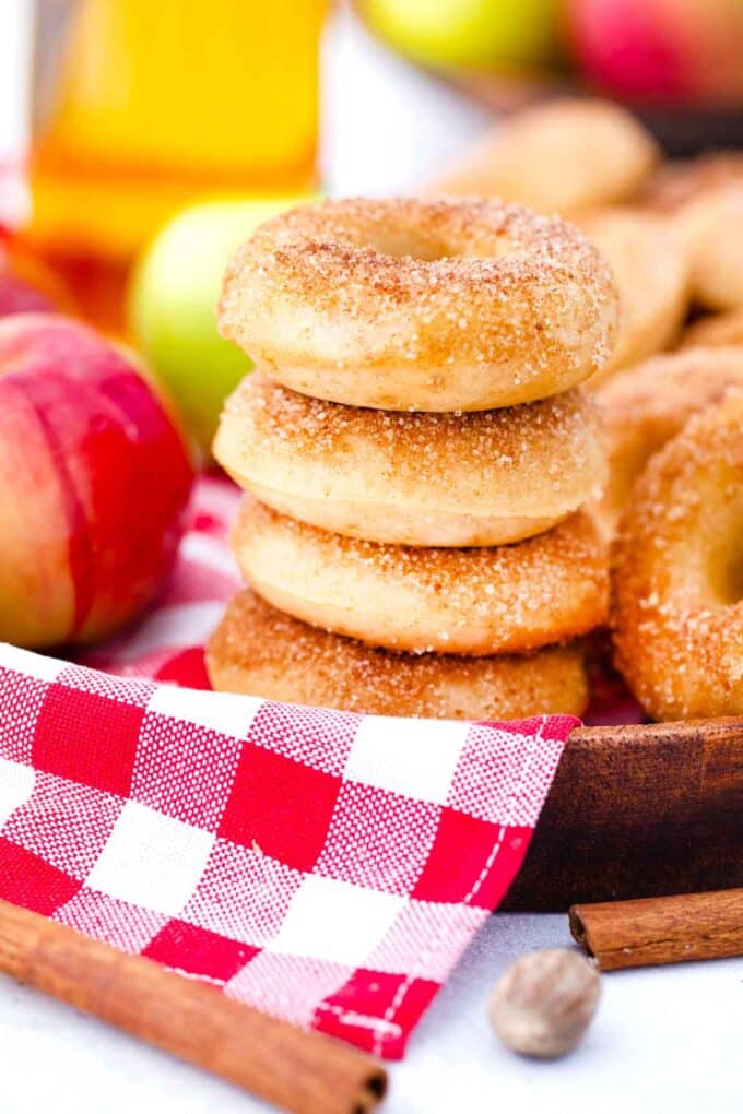 stalked apple cider donuts on a red and white kitchen towel