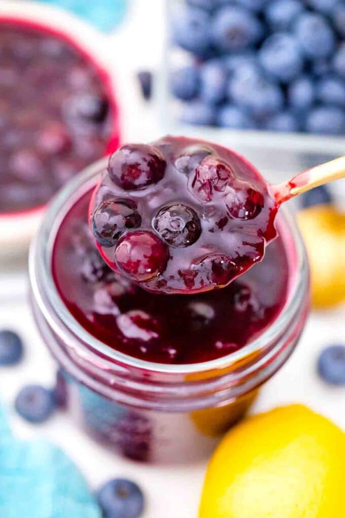 overhead shot of a spoonful of blueberry pie filling on top of a mason jar