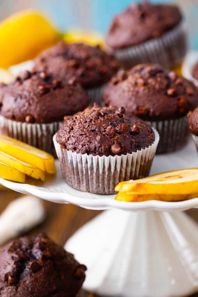 A cake platter with homemade chocolate banana bread muffins.
