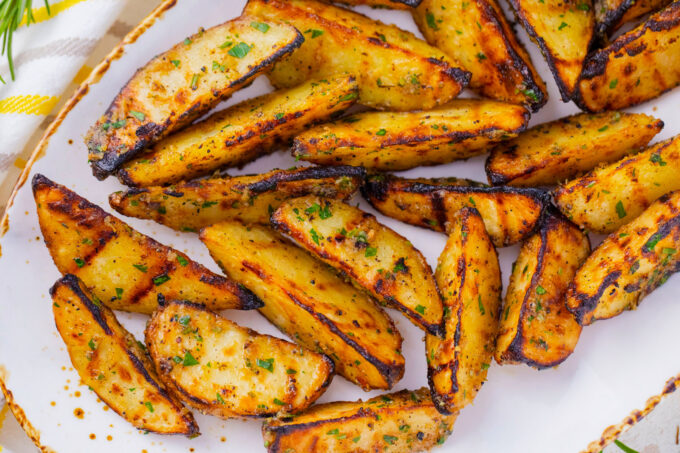Overhead shot of a serving plate with grilled potatoes.