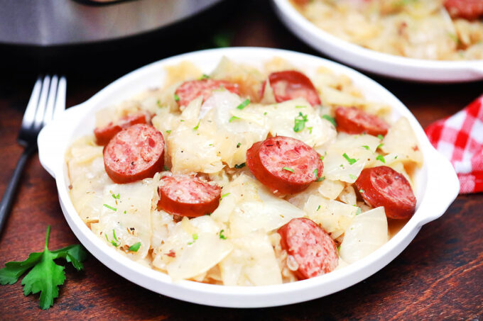 A dinner plate with instant pot cabbage and sausage.
