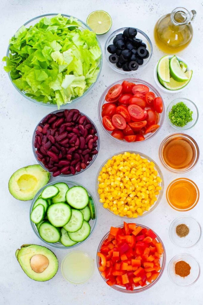 overhead shot of mexican salad ingredients in bowls