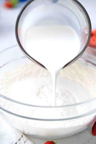 pouring milk into flour mixture
