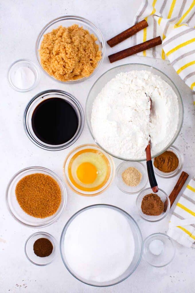 molasses cookies ingredients in individual bowls on a table