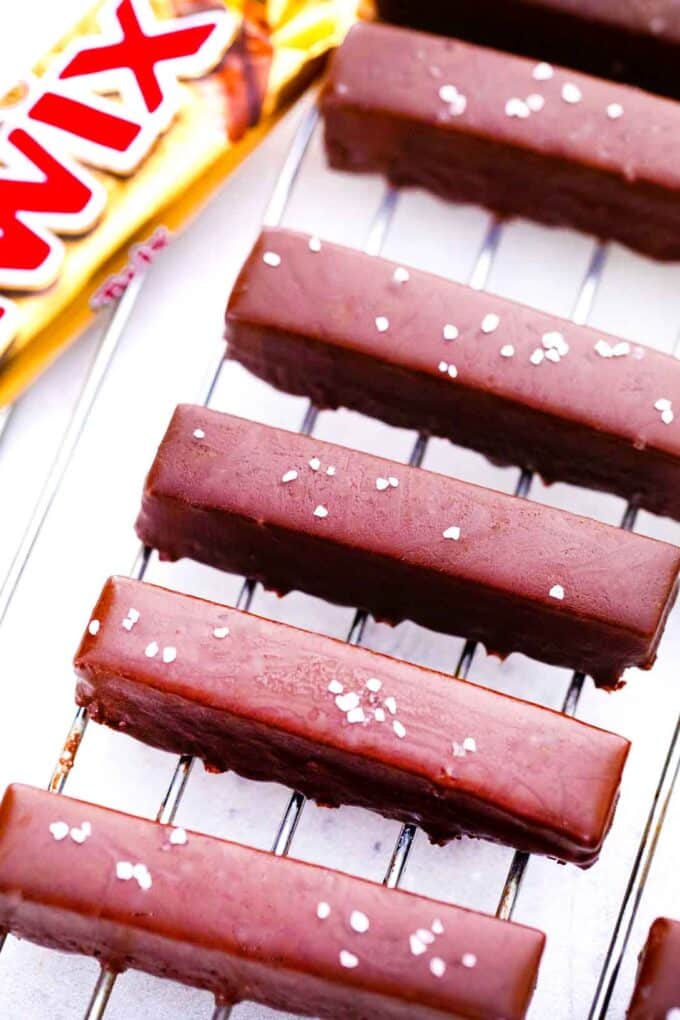 overhead shot of peanut butter twix bars topped with sea salt arranged on a wire rack