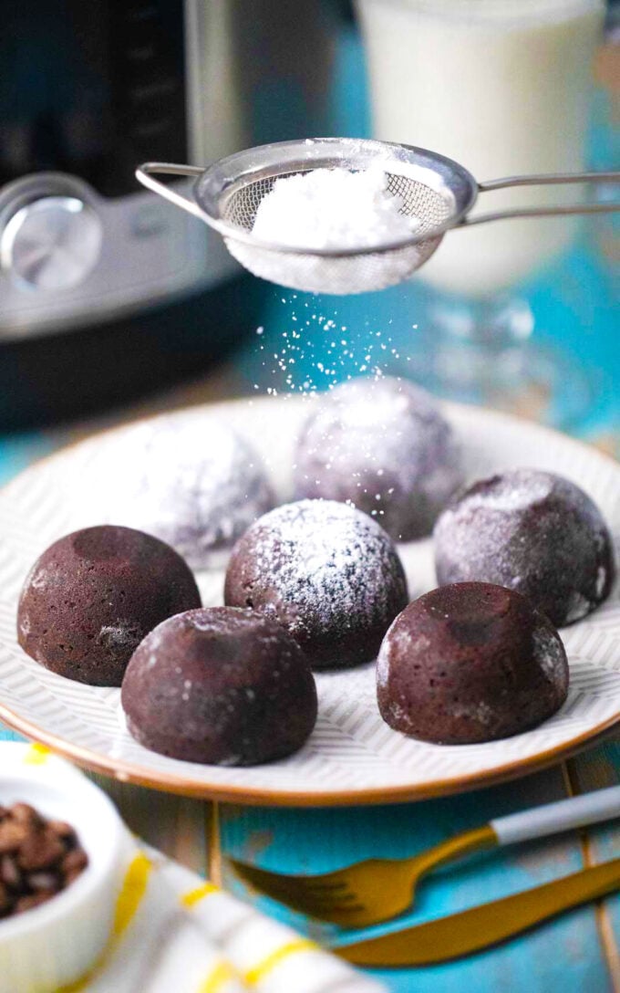 Dusting instant pot brownie bites with powdered sugar.