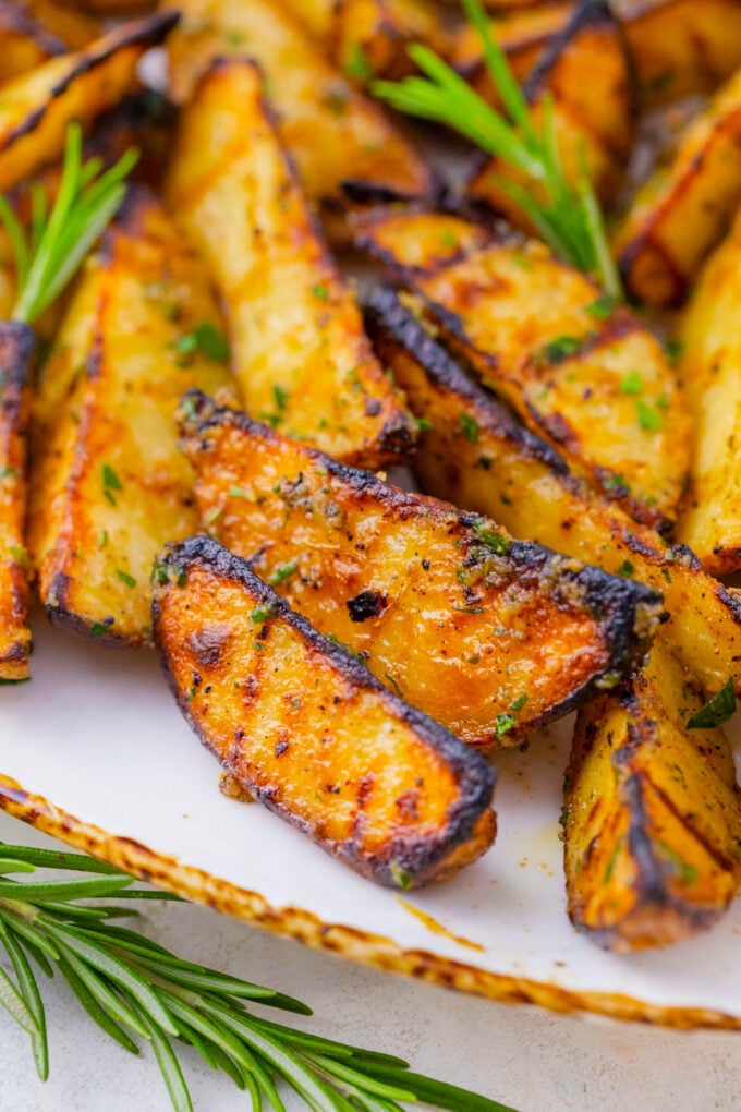 Grilled potatoes with char marks.