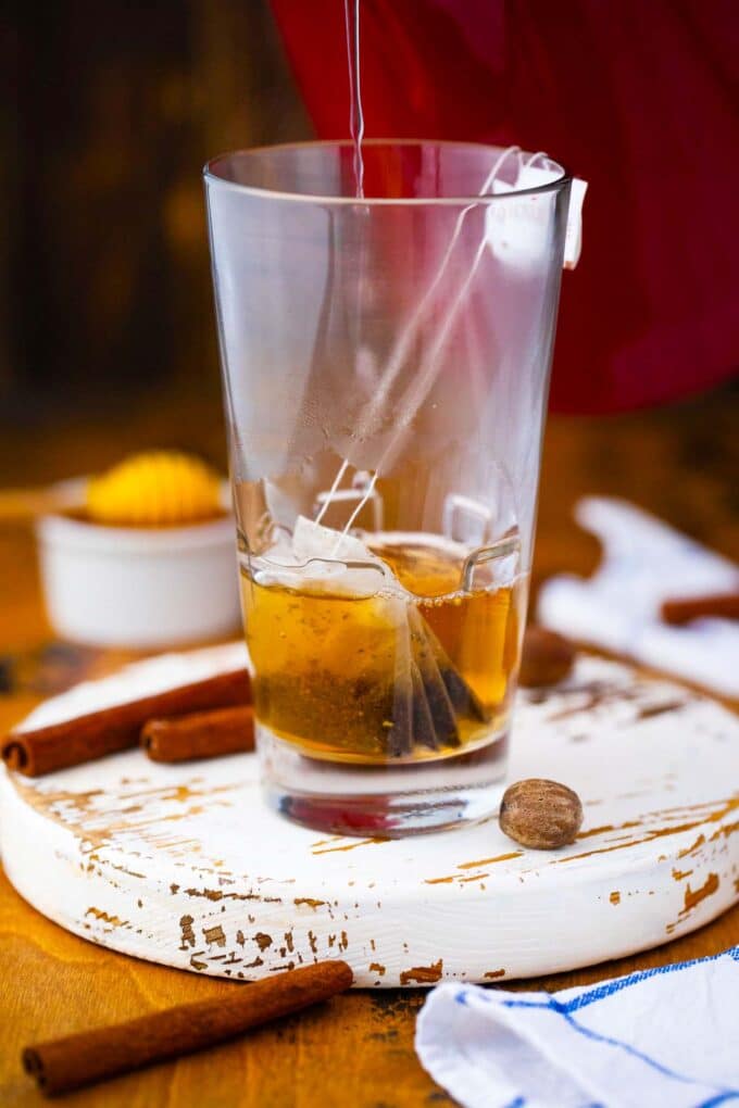 a tea bag in a glass with hot water