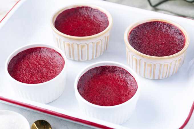 Four ramekins of red velvet creme brulee.