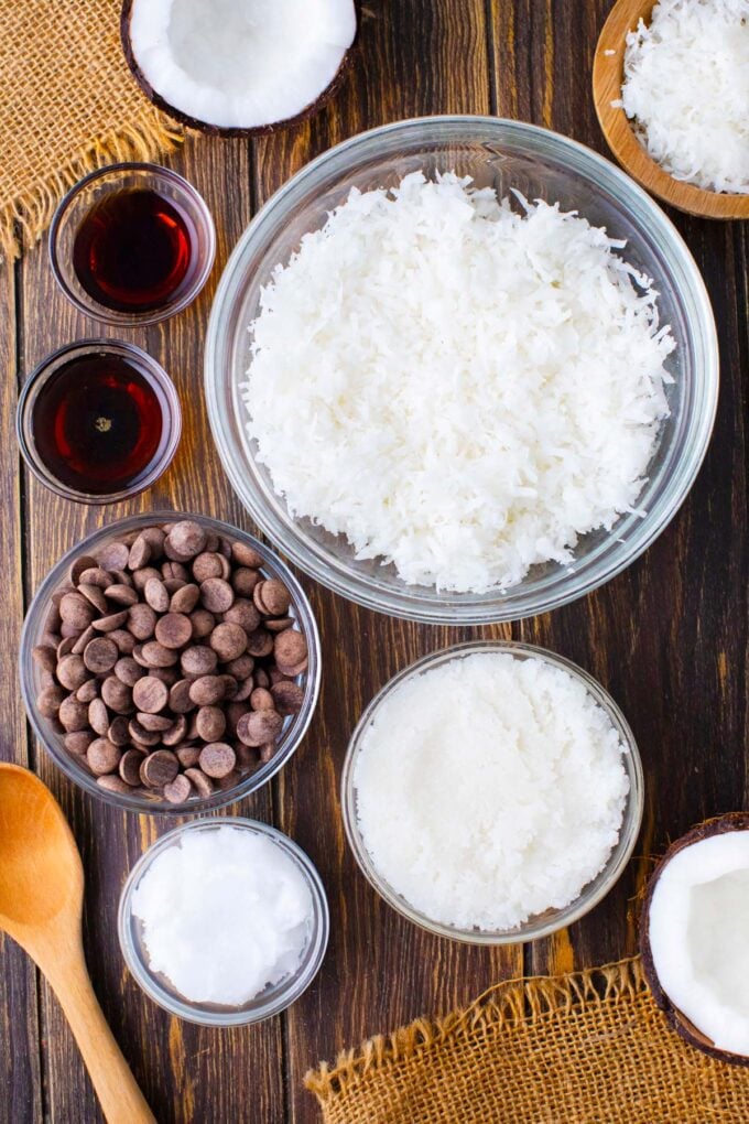 Overhead shot of coconut crack bars ingredients in bowls on a wooden table.