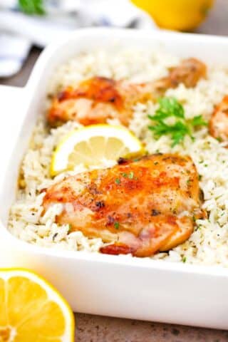 close shot of golden chicken thighs over rice in a casserole